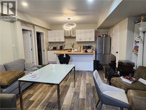 Hamilton apartment for rent - A modern kitchen and living room with a glass table and a grey sofa.