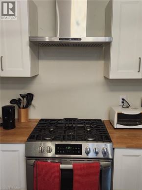 Hamilton apartment for rent - A stove top with a red towel on it.