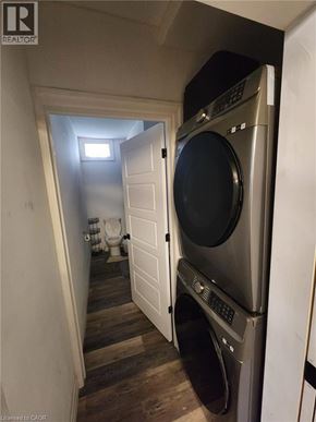 Hamilton apartment for rent - A washer and dryer are in a small room with a toilet and sink in the background.