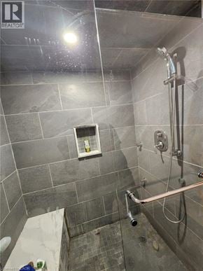 Hamilton apartment for rent - A shower area with a glass door and a glass shower head.