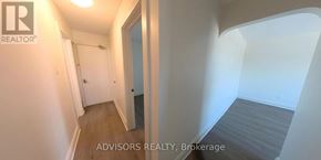 Toronto (Long Branch) apartment for rent - A hallway with a door on the left and a bedroom on the right.