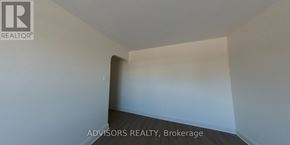 Toronto (Long Branch) apartment for rent - A room with a logo that says "REALTOR" on the wall.