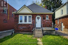 Hamilton (Westdale) apartment for rent - A small red brick house with a white door and a small front porch.