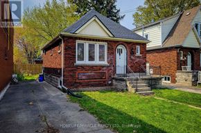 Hamilton (Westdale) apartment for rent - A small red brick house with a white door and windows.