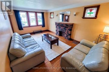Hamilton (Westdale) apartment for rent - A living room with leather couches and a fireplace.