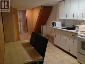 Toronto (Caledonia-Fairbank) apartment for rent - A kitchen with white cabinets and a wooden floor.
