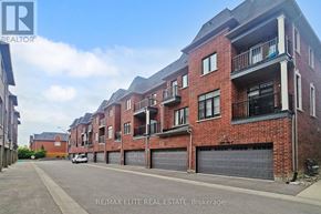 Markham (Unionville) townhouse for rent - A red brick apartment building with a balcony on the second floor.