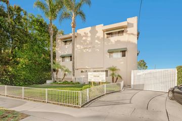 North Hollywood apartment for rent - A white building with a sign in front of it.