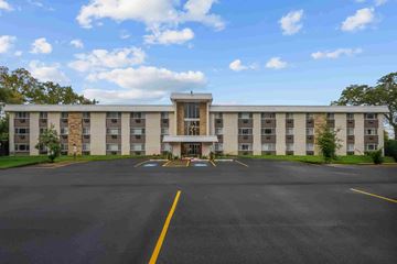 Libertyville apartment for rent - A large building with a parking lot in front of it.