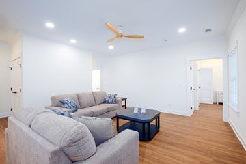 Statesboro apartment for rent - A living room with a grey couch and a blue coffee table.