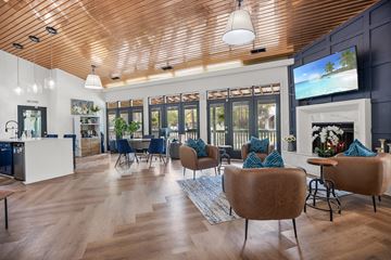 Wilmington apartment for rent - A modern living room with a wooden ceiling and a television on the wall.