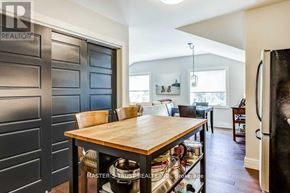 Aurora (Aurora Heights) apartment for rent - A kitchen with a wooden table and a black refrigerator.