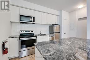 Oshawa (Samac) townhouse for rent - A kitchen with granite countertops and stainless steel appliances.