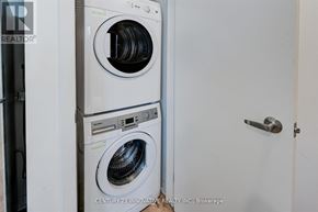 Oshawa (Samac) townhouse for rent - A white washing machine and dryer stacked on top of each other in a small room.