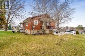 Clarence-Rockland apartment for rent - A red brick house with a white window and a bicycle leaning against the wall.