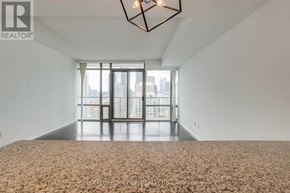 Toronto (Bay Street Corridor) condo for rent - A bedroom with a large bed and a chandelier.