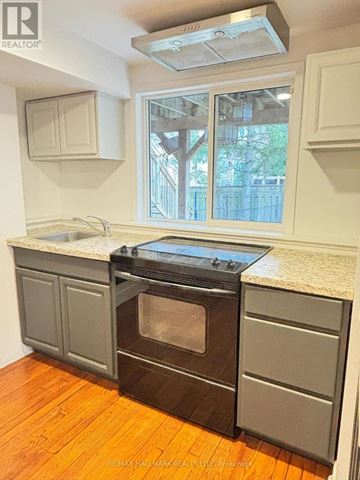 Newmarket (Summerhill Estates) apartment for rent - A kitchen with a black oven and wooden floors.