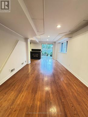 Newmarket (Summerhill Estates) apartment for rent - A spacious hallway with wooden floors and white walls.