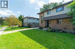 Kitchener apartment for rent - A house with a well-maintained lawn in front of it.