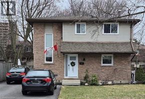 Kitchener apartment for rent - A house with a car parked in front of it.