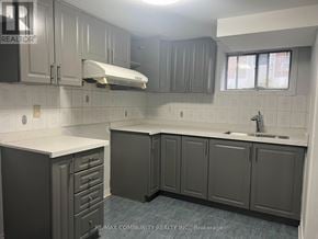 Toronto (Woburn) apartment for rent - A kitchen with grey cabinets and a white counter top.