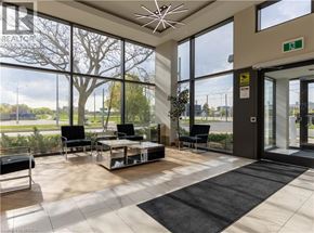 Brantford condo for rent - A waiting area with a glass wall and a view of the outside.