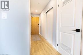 Brantford condo for rent - A hallway with a door on the right and a door on the left.