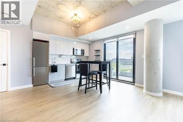 Brantford condo for rent - A modern kitchen with a dining table and chairs.