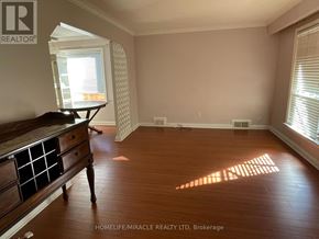 Toronto (Kennedy Park) apartment for rent - A room with wooden floors and a window letting in sunlight.