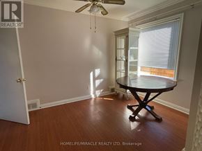 Toronto (Kennedy Park) apartment for rent - A room with a table and a fan.