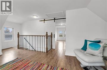 Hamilton apartment for rent - A living room with a white couch and a colorful rug.