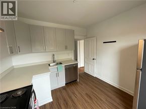 Hamilton apartment for rent - A kitchen with white cabinets and a black stove top.