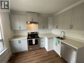 Hamilton apartment for rent - A kitchen with white cabinets and a wooden floor.