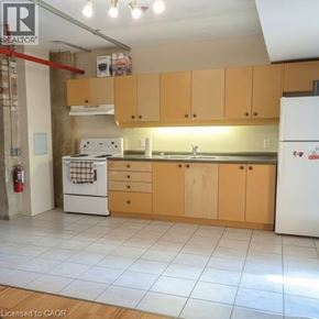 Waterloo condo for rent - A kitchen with wooden cabinets and a white fridge.