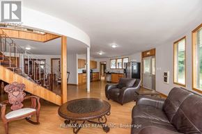 Adjala-Tosorontio apartment for rent - A living room with a staircase and a couch.