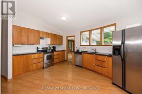 Adjala-Tosorontio apartment for rent - A kitchen with wooden cabinets and stainless steel appliances.