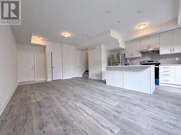 Mississauga (Erin Mills) townhouse for rent - A spacious kitchen with white cabinets and a grey floor.