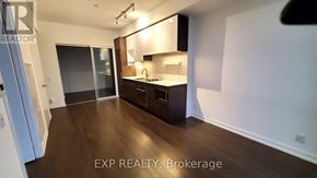 Vaughan (Vaughan Corporate Centre) condo for rent - A kitchen with dark wood floors and white walls.