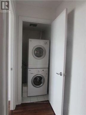 Toronto (Agincourt South-Malvern West) condo for rent - A white washing machine and dryer in a small laundry room.