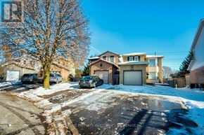 Oshawa (Pinecrest) apartment for rent - A residential street with houses and cars on a snowy day.