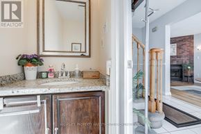 Oshawa (Pinecrest) apartment for rent - A bathroom with a marble countertop and a large mirror.
