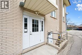 Kitchener apartment for rent - A house with a white door and a sign that says "REALTOR" on the wall.