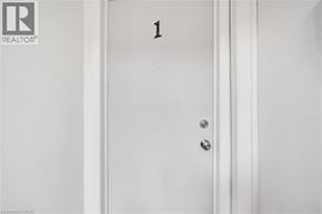 Kitchener apartment for rent - A white door with a number 1 on it.
