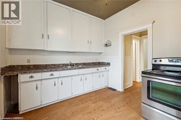 Hamilton apartment for rent - A kitchen with white cabinets and a stainless steel oven.