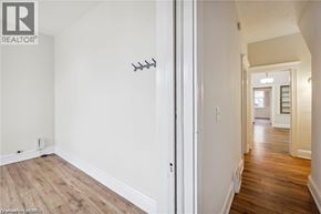 Hamilton apartment for rent - A hallway with a white door and a light switch on the wall.