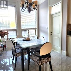Richmond apartment for rent - A dining room with a table set for two and a chandelier.