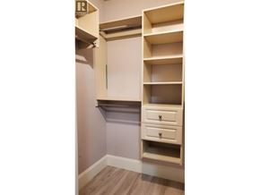 Richmond apartment for rent - A white shelving unit with a drawer is mounted on a wall.