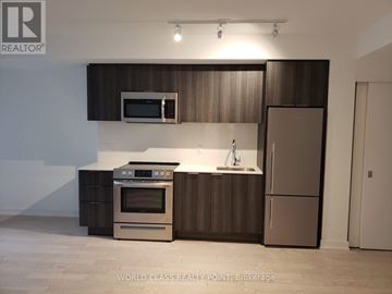 Toronto (Church-Yonge Corridor) condo for rent - A modern kitchen with a stainless steel oven and refrigerator.