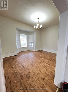 London East (East G) apartment for rent - A room with wooden flooring and a chandelier.