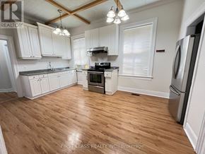 London East (East G) apartment for rent - A kitchen with wooden floors and white cabinets.